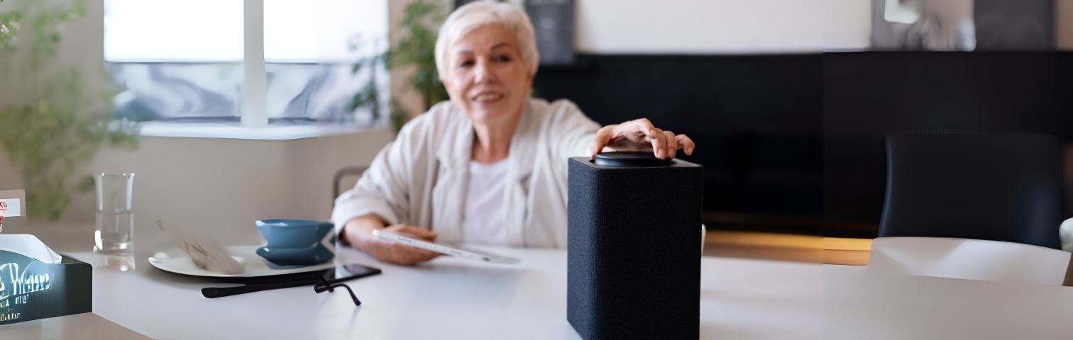 Senior using voice assistant and smart home devices in comfortable living room for safety and convenience