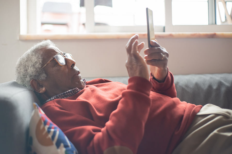 Senior citizen comfortably using a smartphone